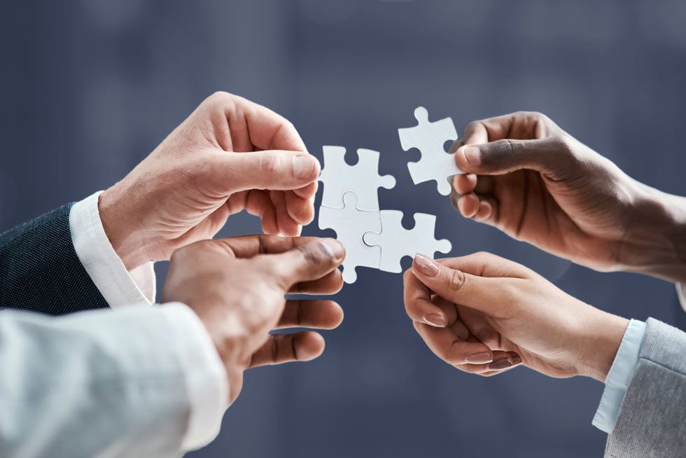 group of employees holding puzzle pieces