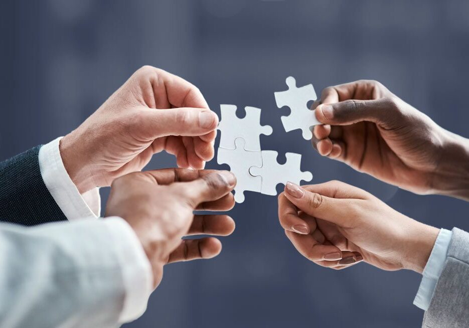 group of employees holding puzzle pieces
